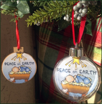 Peace on Earth ornament with baby Jesus in a manger by DJ Inkers